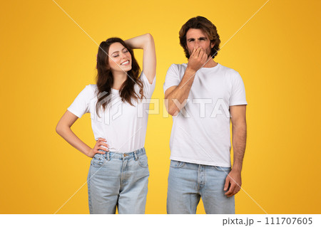 Relaxed woman smiling with hand behind head and a man pinching his nose 111707605