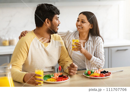Married couple enjoying time together, cuddling, talking, eating lunch 111707706