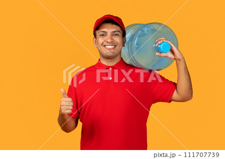 courier guy holds clear water bottle approving thumbs up, studio 111707739