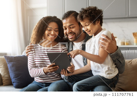 Cheerful African American Parents And Little Son Relaxing With Digital Tablet 111707761