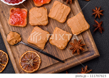 Delicious nutritious sandwiches with peanut butter, strawberry jam 111707823