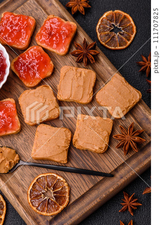 Delicious nutritious sandwiches with peanut butter, strawberry jam Delicious nutritious sandwiches with peanut butter, strawberry jam 111707825