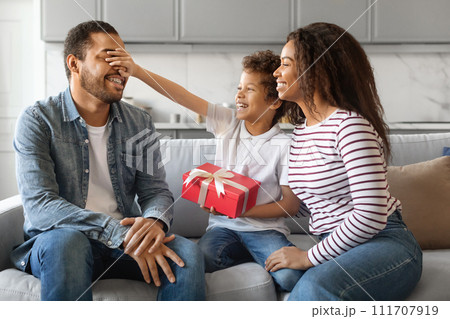 Son And Wife Greeting Young Black Man With Father's Day, Giving Gift 111707919