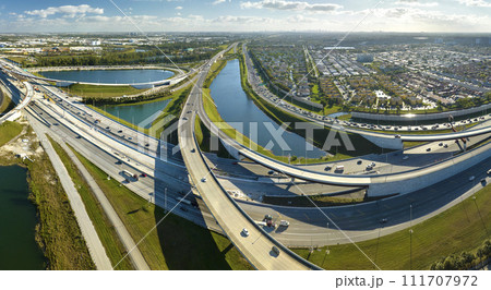 USA transportation infrastructure concept. Above view of wide highway crossroads in Miami, Florida with fast driving cars 111707972