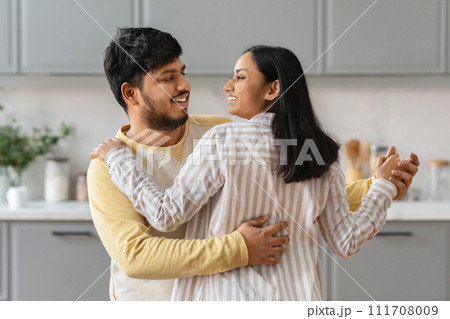 Portrait of beautiful indian couple dancing at kitchen Portrait of beautiful indian couple dancing at kitchen 111708009