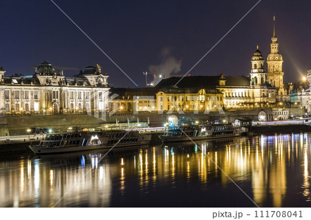 Night cityscape view of historic buildings with reflections in Elbe river in the center of Dresden (Germany). 111708041