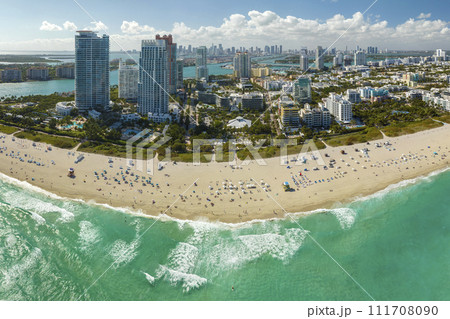 Miami Beach city with high luxury hotels and condos and sandy beachfront. High angle view of tourist infrastructure in southern Florida, USA Miami Beach city with high luxury hotels and condos and sandy beachfront. High angle view of tourist infrastructure in southern Florida, USA 111708090