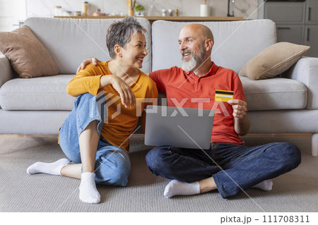Online Banking. Happy Older Couple Using Laptop And Credit Card At Home Online Banking. Happy Older Couple Using Laptop And Credit Card At Home 111708311