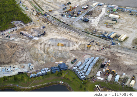Development of residential housing in US suburbs. Beginning of construction works on prepared ground. Large building site with scattered equipment in american rural area. Real estate market in USA 111708340