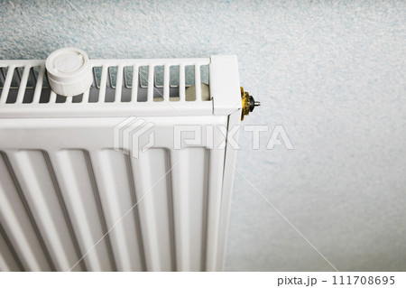 Central heating in well-maintained modern building. Adjustment sensor of heater to change temperature Central heating in well-maintained modern building. Adjustment sensor of heater to change temperature 111708695