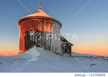 Winter, sunrise time, wooden Roman catholic chapel  in snezka, mountain on the border between Czech Republic and Poland. 111708969