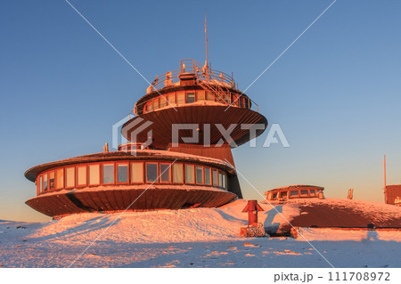 Winter, sunrise time,  disc shaped meteorological observatory in snezka, mountain on the border between Czech Republic and Poland. 111708972