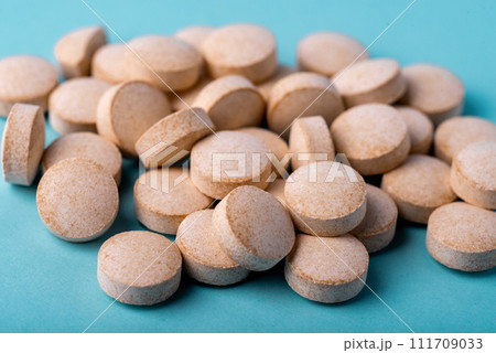 Orange pills vitamin C. pills on blue background. Orange pills vitamin C. pills on blue background. 111709033