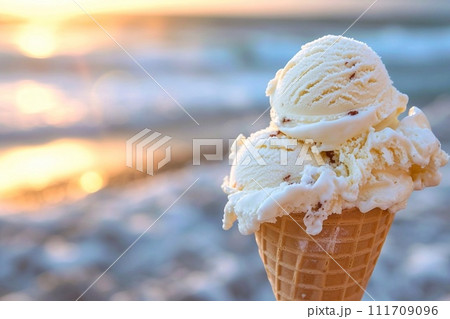 Vanilla ice cream in a waffle cone on the beach. Vanilla ice cream in a waffle cone on the beach. 111709096