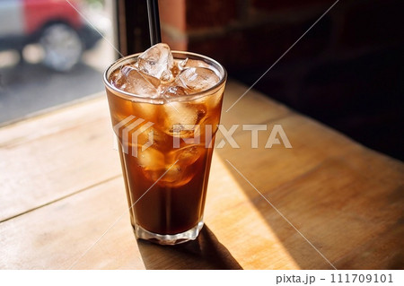 Coffe with ice cubes on wooden table in coffee shop Coffe with ice cubes on wooden table in coffee shop 111709101