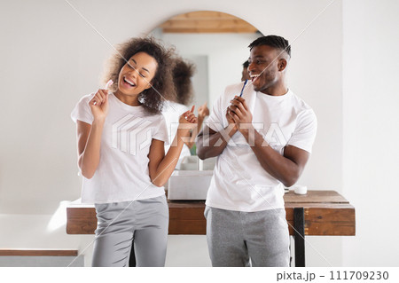 Black Couple Singing While Brushing Teeth in Home Bathroom 111709230