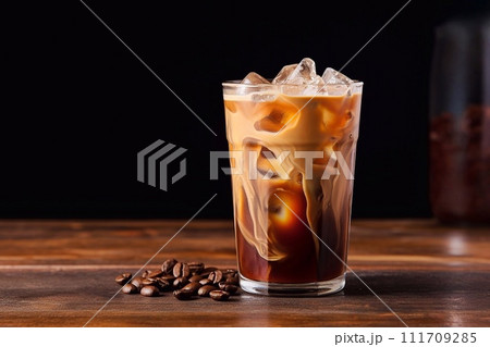 Iced coffee in a glass on a wooden table 111709285