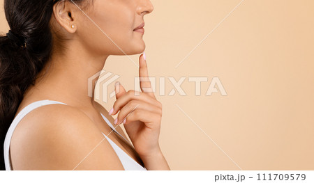 Chin Augmentation. Side view shot of unrecognizable young woman touching her face 111709579