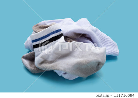 Dirty white socks on blue background. Dirty white socks on blue background. 111710094