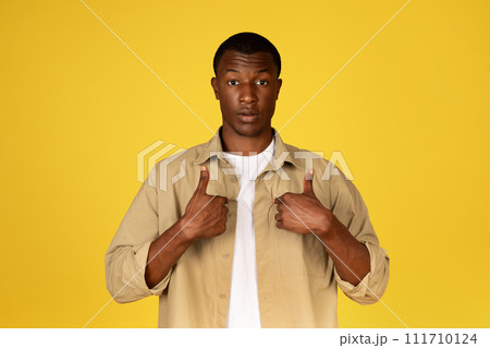 Shocked confused millennial black man in casual points fingers at himself, feels doubt, stress 111710124