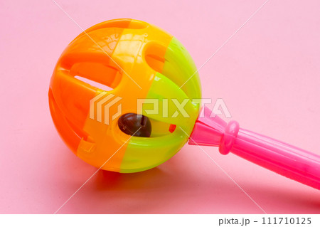 Colorful baby rattle on pink background. Copy space Colorful baby rattle on pink background. Copy space 111710125