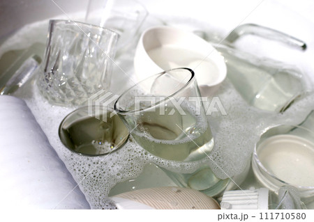 Washing used drinking glasses and cups 111710580