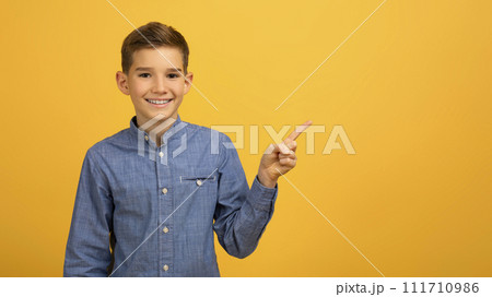 Check This. Happy Male Kid Pointing Aside At Copy Space With Finger 111710986