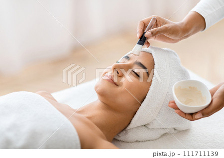Soothing spa facial treatment for relaxed woman 111711139