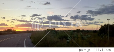 sunset over road 111712780