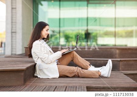 Happy pretty calm millennial european lady enjoy work, typing by laptop Happy pretty calm millennial european lady enjoy work, typing by laptop 111713038