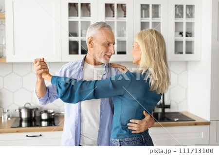 Happy Retirement. Beautiful Senior Couple Dancing In Kitchen Interior 111713100