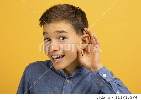 Curious Teen Boy Holding Hand Near Ear Trying To Overhear Something Curious Teen Boy Holding Hand Near Ear Trying To Overhear Something 111713974