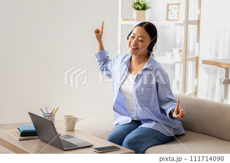 Asian woman listening to music, have break, working from home Asian woman listening to music, have break, working from home 111714090