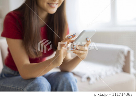 Online Shopping. Smiling Young Woman Using Smartphone At Home, Cropped Shot 111714365