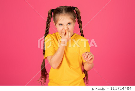 Disgusting Concept. Emotional Little Girl Covering Nose With Hand, Feeling Bad Smell 111714404