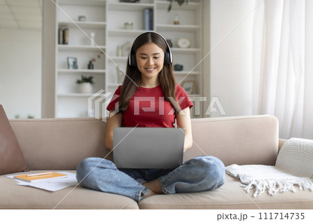 Distance Learning. Young Asian Woman In Headphones Studying With Laptop At Home 111714735