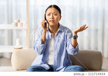 Angry asian woman fighting over phone with boyfriend 111714834