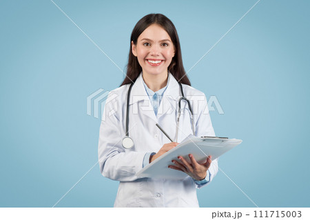 Smiling european female doctor holding clipboard 111715003