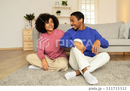 Loving black husband and wife bond through tender hugs indoor Loving black husband and wife bond through tender hugs indoor 111715312