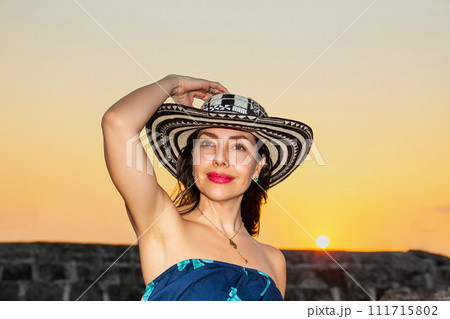 Beautiful woman wearing the traditional Colombian hat called Sombrero Vueltiao at the historical walls of Cartagena de Indias Beautiful woman wearing the traditional Colombian hat called Sombrero Vueltiao at the historical walls of Cartagena de Indias 111715802