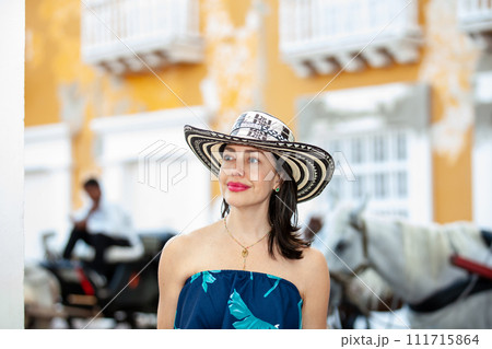 Beautiful woman wearing the traditional Colombian hat called Sombrero Vueltiao at the Customs Square on the historical streets of the Cartagena de Indias walled city Beautiful woman wearing the traditional Colombian hat called Sombrero Vueltiao at the Customs Square on the historical streets of the Cartagena de Indias walled city 111715864
