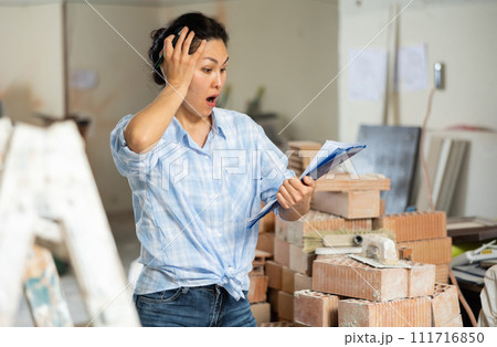 Portrait of an emotional woman, who saw an error in the documentation Portrait of an emotional woman, who saw an error in the documentation 111716850