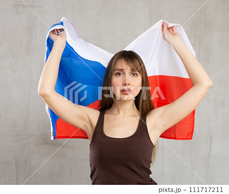 Young sad woman holding Czech Republic flag Young sad woman holding Czech Republic flag 111717211
