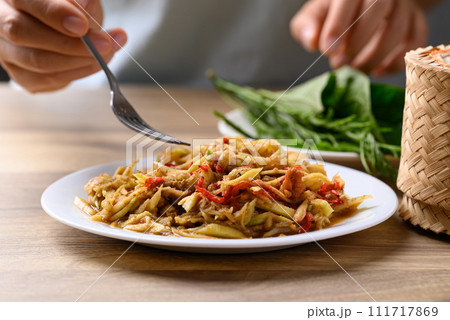 Thai food, Spicy mango salad with dry shrimp eating with fresh vegetables and sticky rice 111717869