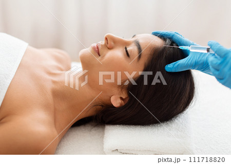 Cosmetologist does prp therapy against hair loss for indian woman 111718820