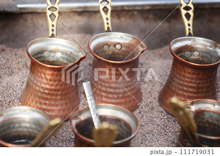 top view of making traditional turkish coffee on sand top view of making traditional turkish coffee on sand 111719031