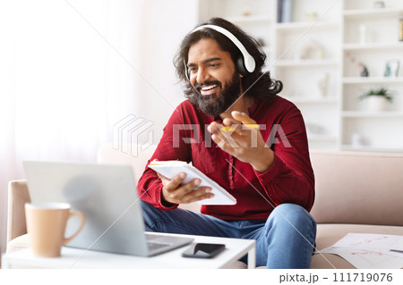 Positive millennial indian man have online training, using laptop 111719076