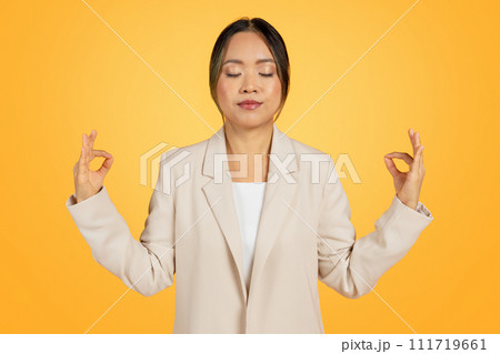 Calm millennial korean lady in studio work meditation, finding moment of peace Calm millennial korean lady in studio work meditation, finding moment of peace 111719661