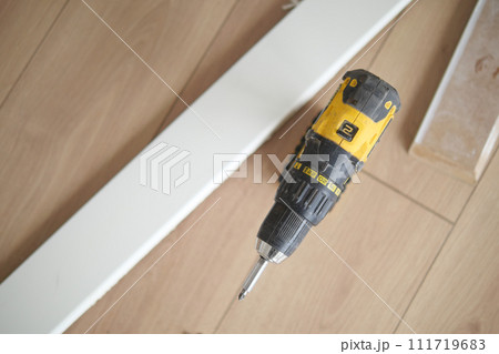 An electric screwdriver is on the floor,  111719683
