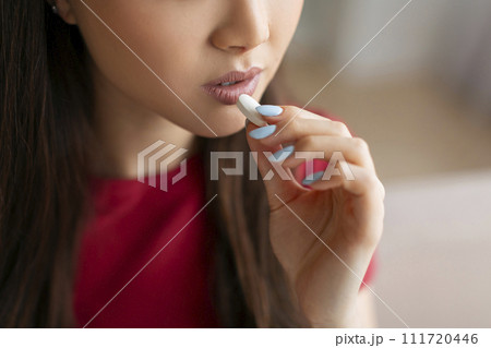 Unrecognizable Young Woman Taking White Pill At Home 111720446